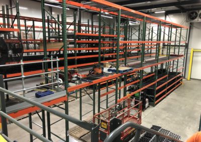 Rack supported mezzanine system installed in a warehouse refrigerator