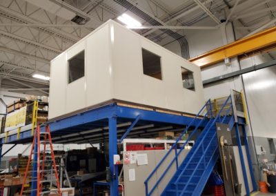 Portafab modular office installed on top of an elevated mezzanine structure