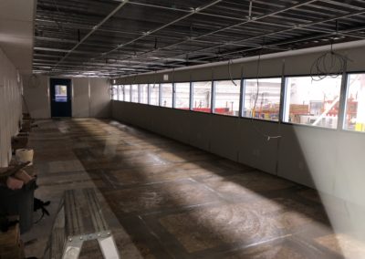 Interior of two-tier modular office, on second level before vinyl flooring