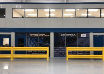 Front view of two-tier modular office with window decals, Cogan Yellow Guardrail forklift